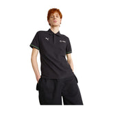 Person wearing a Puma MAPF1 Polo Shirt - Black with logos on a white background